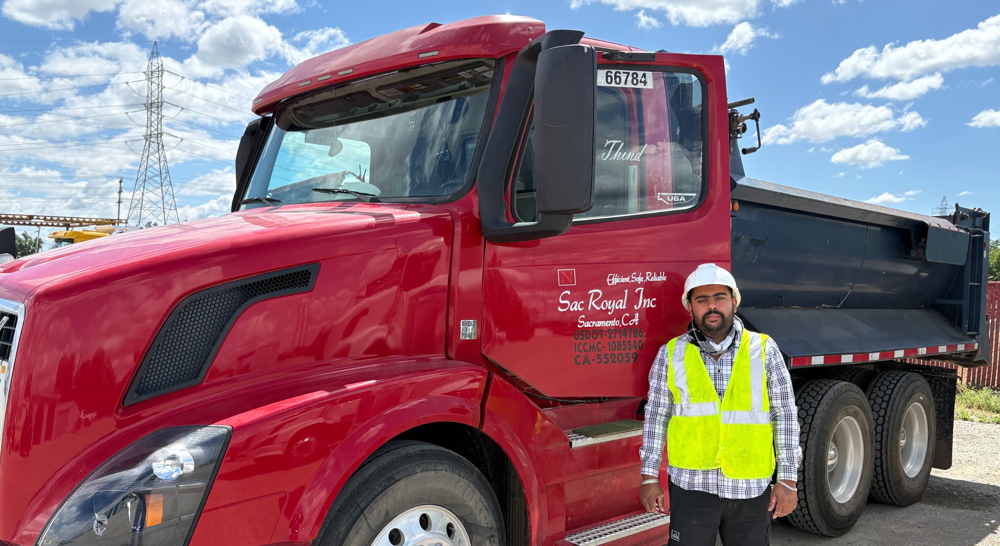 SacRoyal red dump truck and driver